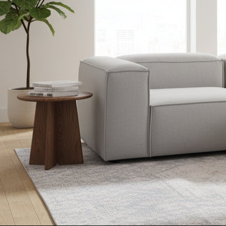 A structured corner module with a single arm, designed to connect seamlessly within modular layouts while maintaining a clean, modern silhouette.