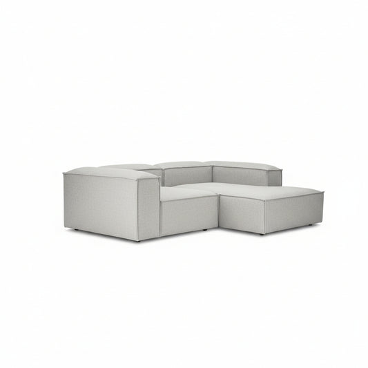A contemporary two-seater with a seamless chaise extension, designed for relaxed lounging without compromising on its clean, architectural form.