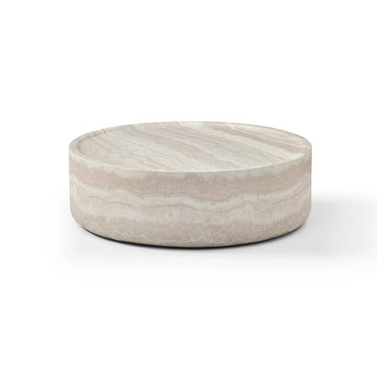 The Cilano Coffee Table is shown in a full studio view on a clean white background, highlighting its large rounded silhouette and faux travertine finish.