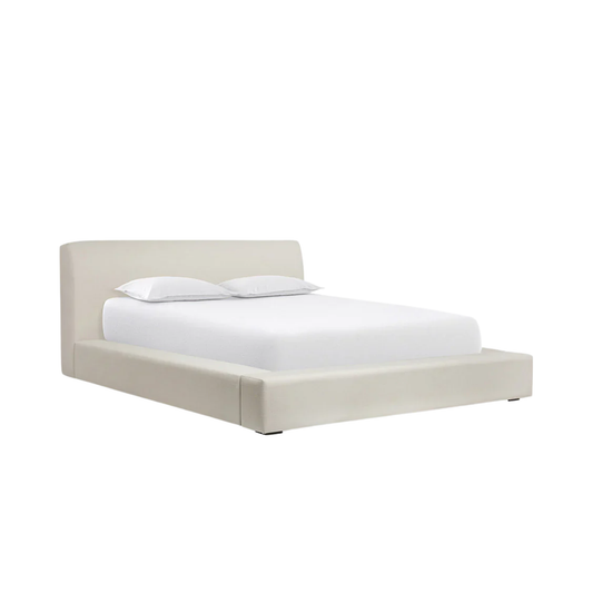modern bed with soft cushioning and neutral fabric finish