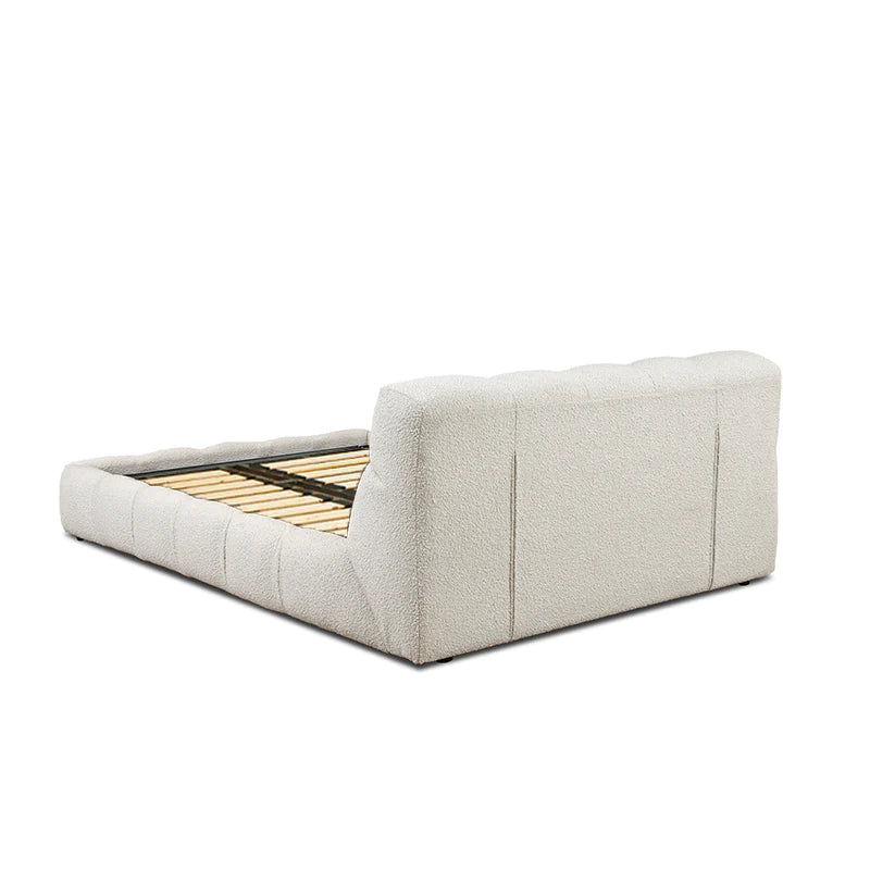 luxury fabric bed with structured headboard and calm bedroom setting