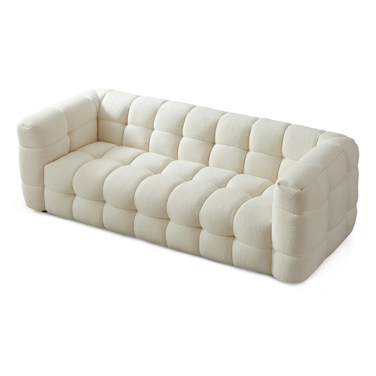 A sculptural, contemporary three-seater in soft boucle, defined by deep channel tufting and a refined low-profile silhouette, available for quick delivery.