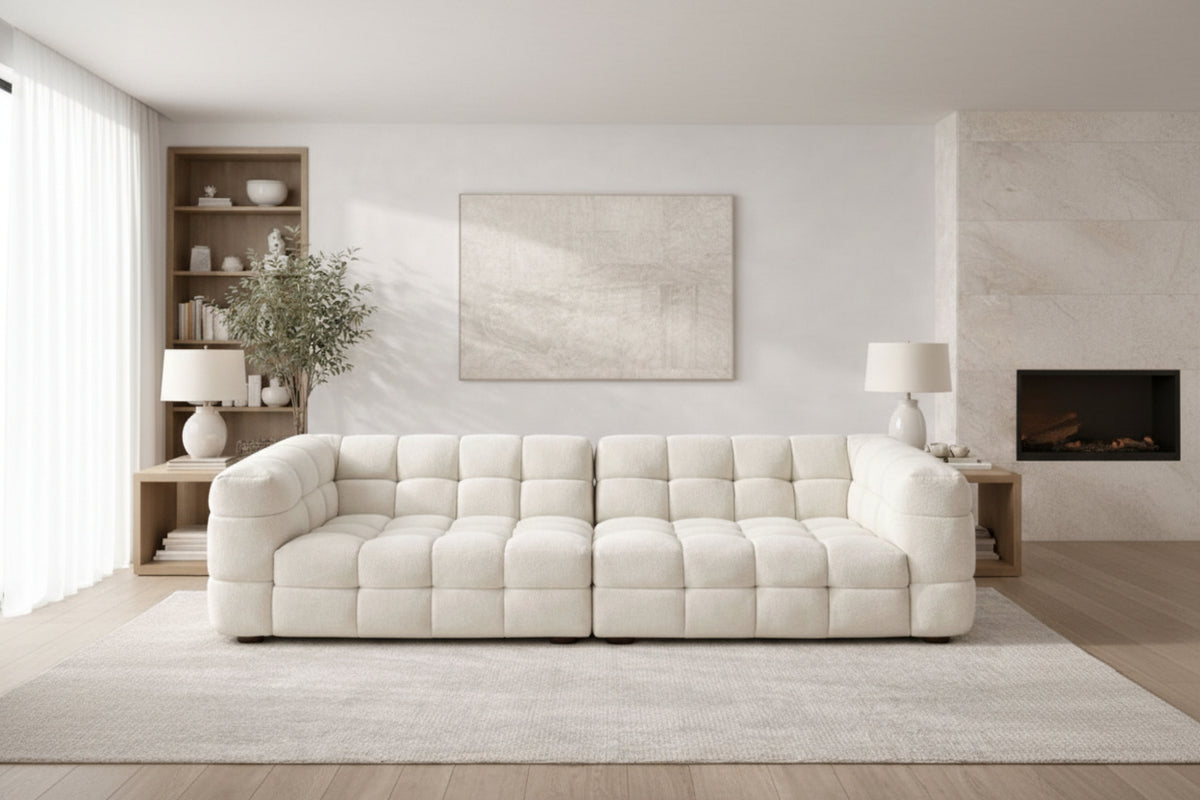 A sculptural, contemporary modular configuration in soft boucle, featuring deep channel tufting and a seamless, low-profile design for modern living spaces.