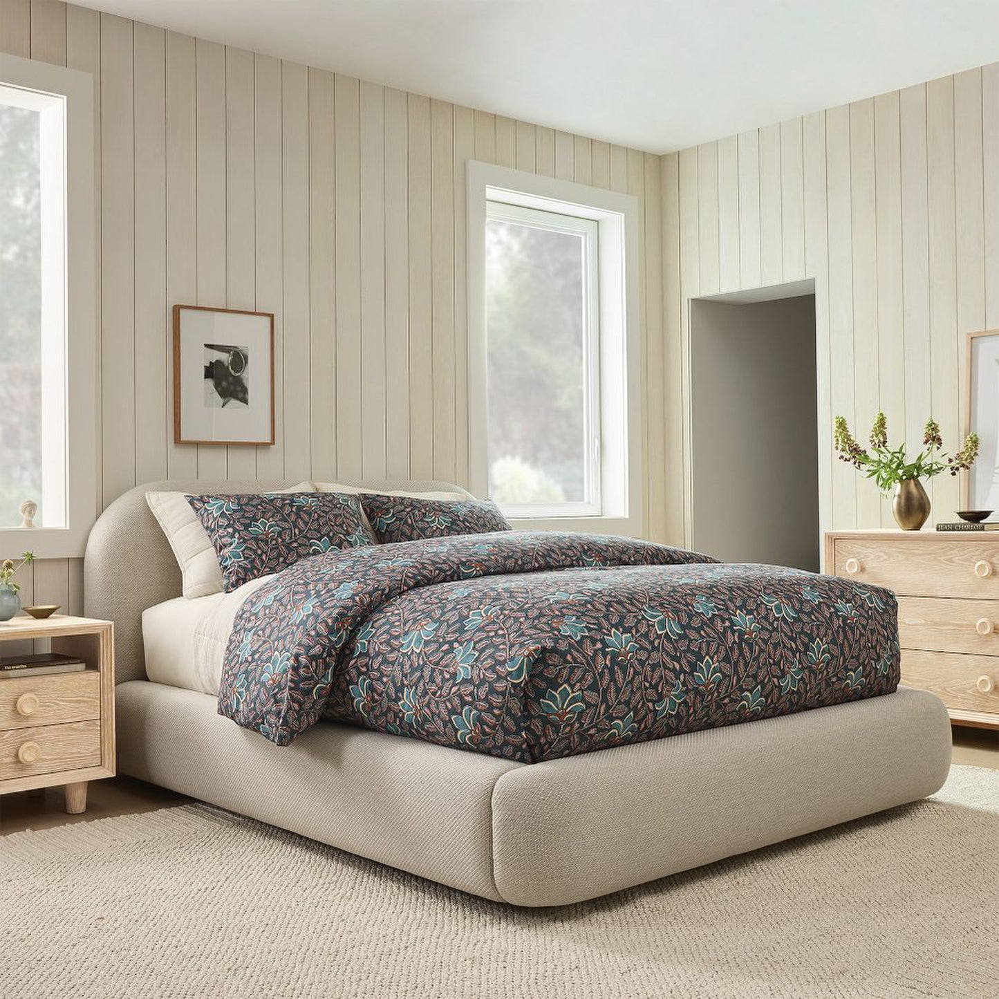 elegant bed with padded headboard and neutral upholstery
