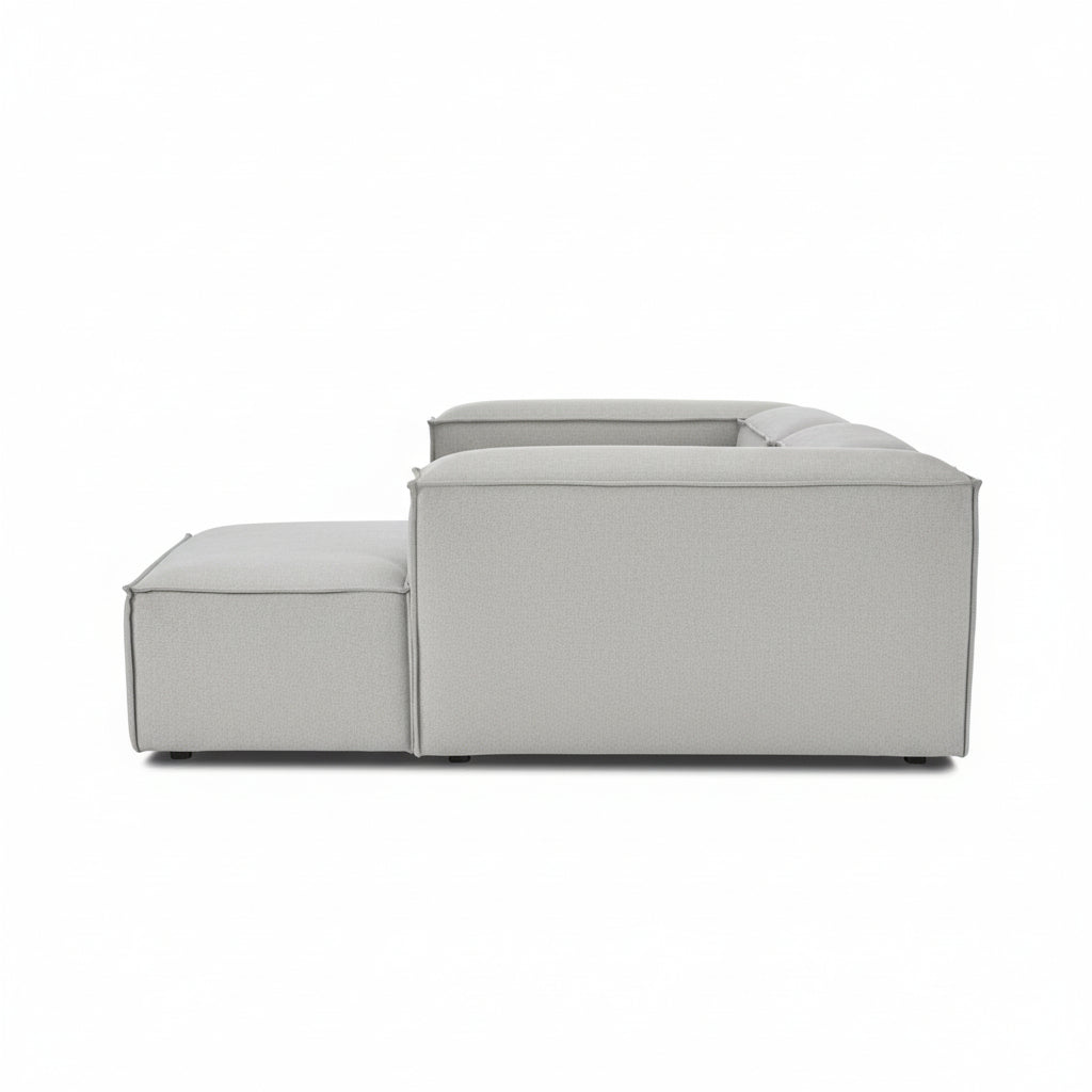Side profile of Alpha 2 seater sofa with chaise end, showing its modular low-profile design in neutral fabric