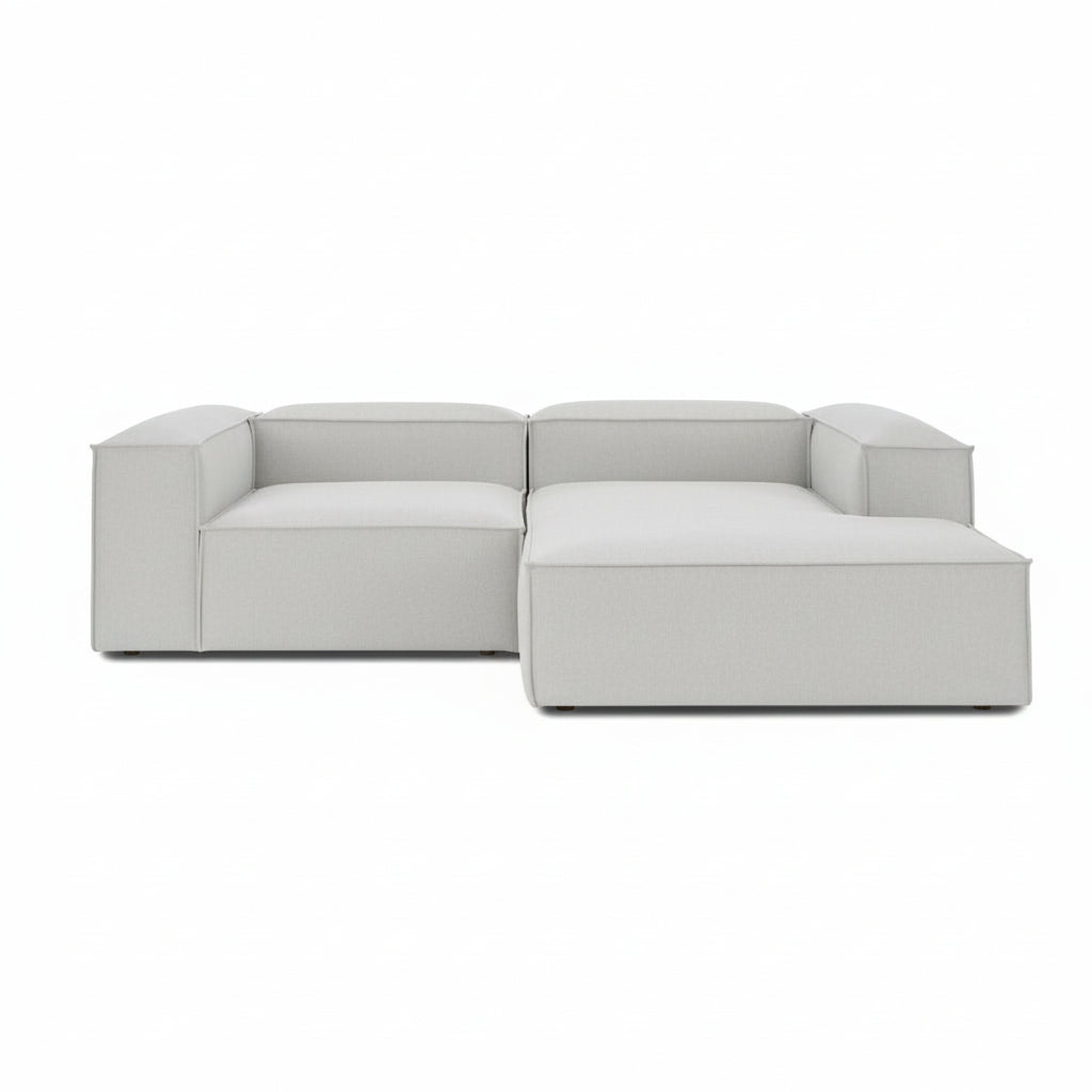 A clean-lined two-seater with an integrated chaise extension, offering a relaxed lounging experience while maintaining the structured, modern aesthetic of the Alpha collection.