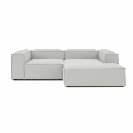 A clean-lined two-seater with an integrated chaise extension, offering a relaxed lounging experience while maintaining the structured, modern aesthetic of the Alpha collection.