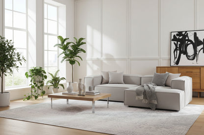 A refined modular composition that balances structure with relaxed comfort, featuring a two-seater base seamlessly extended by a chaise and finished with a defined arm module.