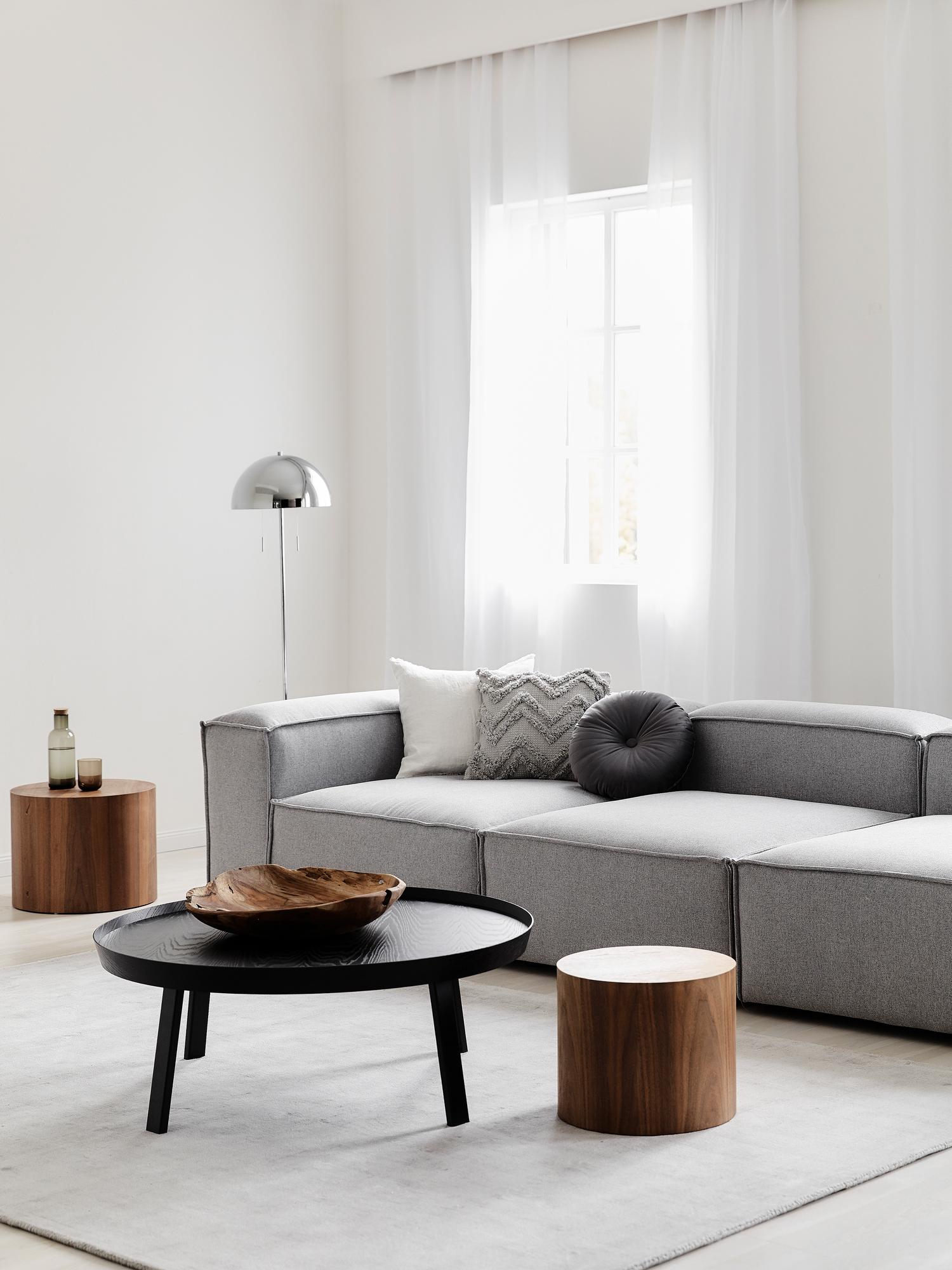 Luxury Alpha 3 seater sofa with soft edges, textured fabric, and sculptural form, styled with contemporary furniture for a high-end interior
