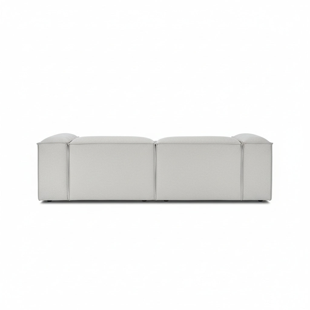 Alpha 2 seater sofa with chaise end in neutral fabric, featuring a low-profile modular design with clean line