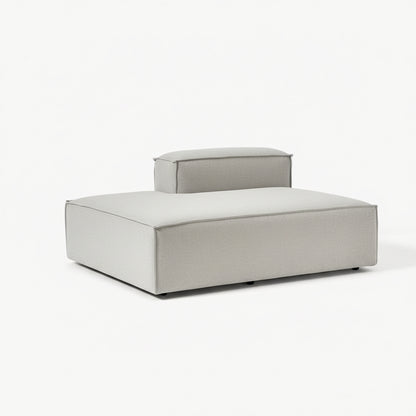 A clean, elongated ottoman with a structured silhouette, designed to extend seating and enhance modular sofa configurations with modern simplicity.