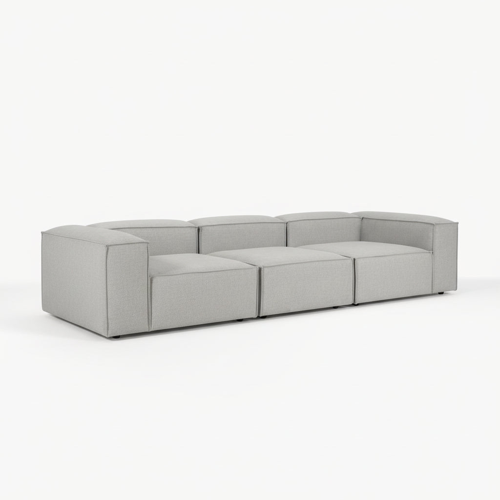 High-end Alpha 3 seater sofa styled in a modern living space with plush cushions, minimalist design, and warm neutral tones creating a refined interior setting
