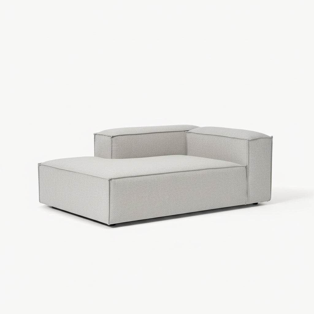 Premium Alpha modular sofa arranged in a corner chaise layout, featuring soft neutral fabric, wide seating, and refined architectural form