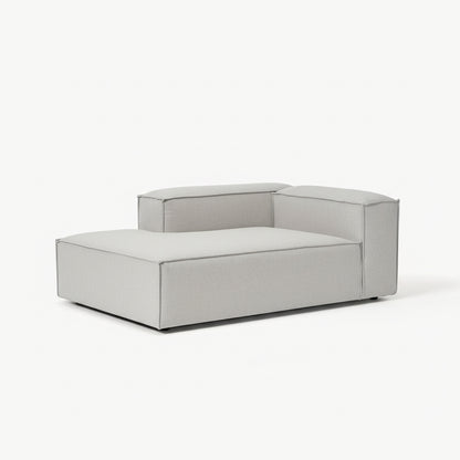 Premium Alpha modular sofa arranged in a corner chaise layout, featuring soft neutral fabric, wide seating, and refined architectural form