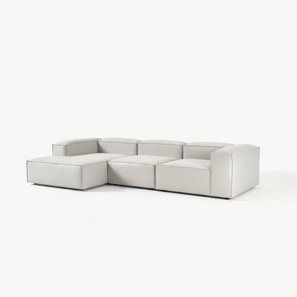 Designer Alpha modular L shape 3 seater sofa in a refined living room setting with plush cushions, neutral tones, and a low-profile modern aesthetic
