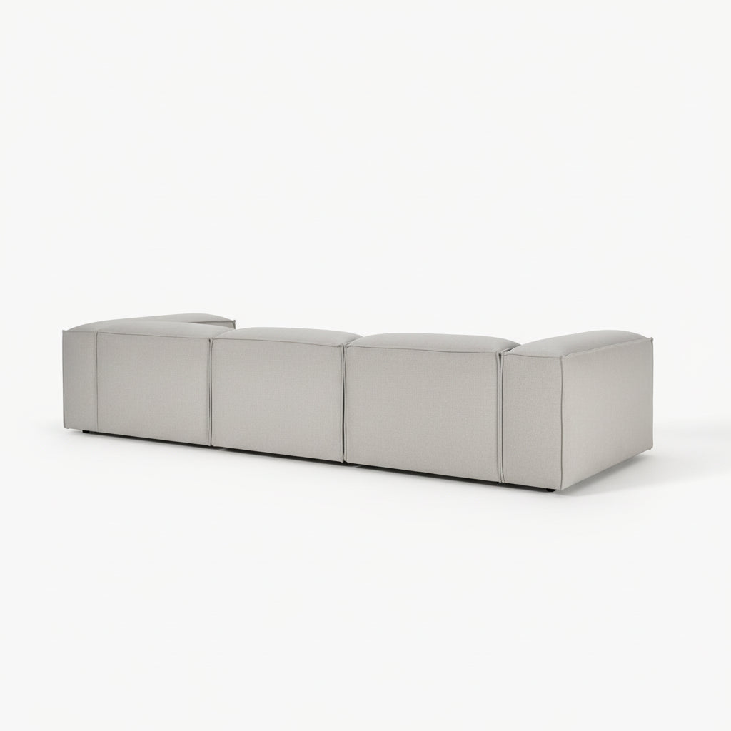 Designer Alpha 3 seater sofa in a spacious contemporary room with natural textures, clean lines, and soft neutral upholstery for an elevated luxury aesthetic

