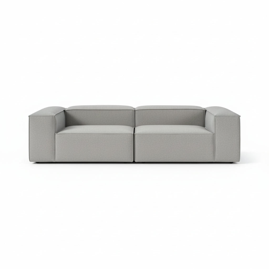 Alpha modular 2 seater sofa with a clean architectural silhouette, deep cushioned seating, and refined neutral upholstery designed for modern living spaces
