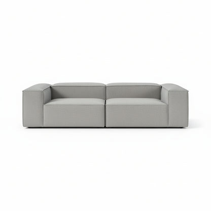 Alpha modular 2 seater sofa with a clean architectural silhouette, deep cushioned seating, and refined neutral upholstery designed for modern living spaces
