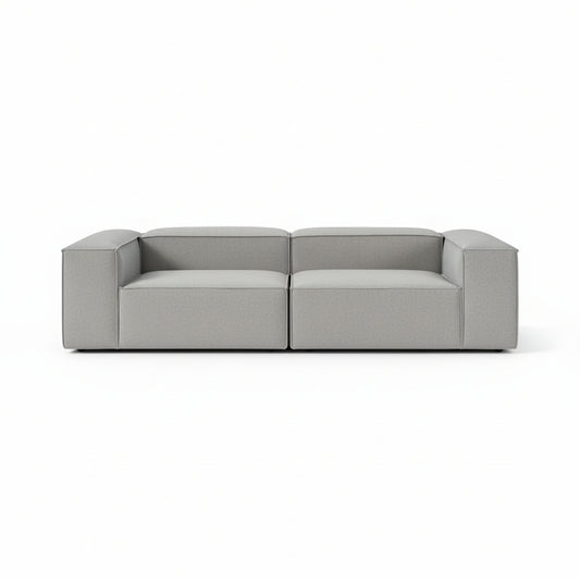 Alpha modular 2 seater sofa with a clean architectural silhouette, deep cushioned seating, and refined neutral upholstery designed for modern living spaces
