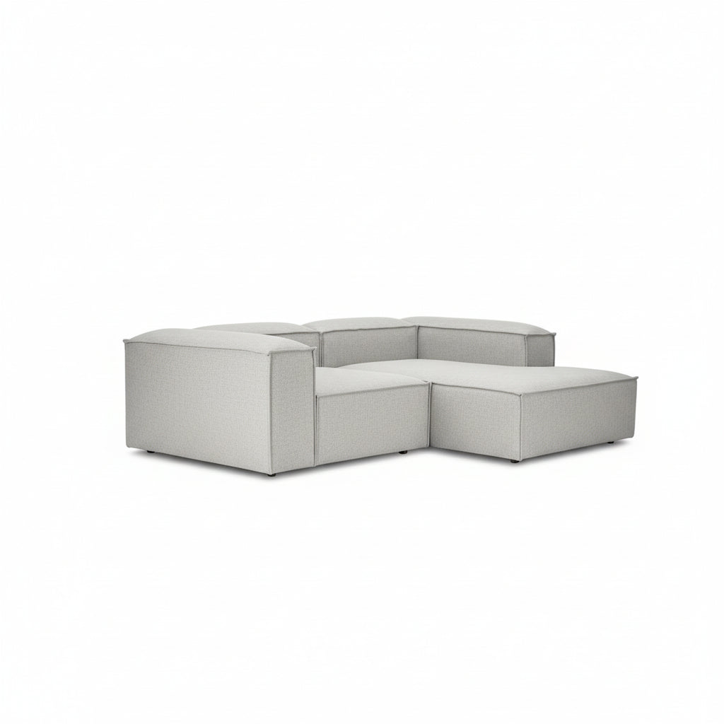 A contemporary two-seater with a seamless chaise extension, designed for relaxed lounging without compromising on its clean, architectural form.
