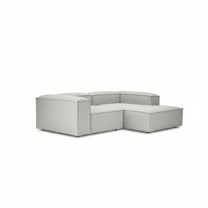 A contemporary two-seater with a seamless chaise extension, designed for relaxed lounging without compromising on its clean, architectural form.
