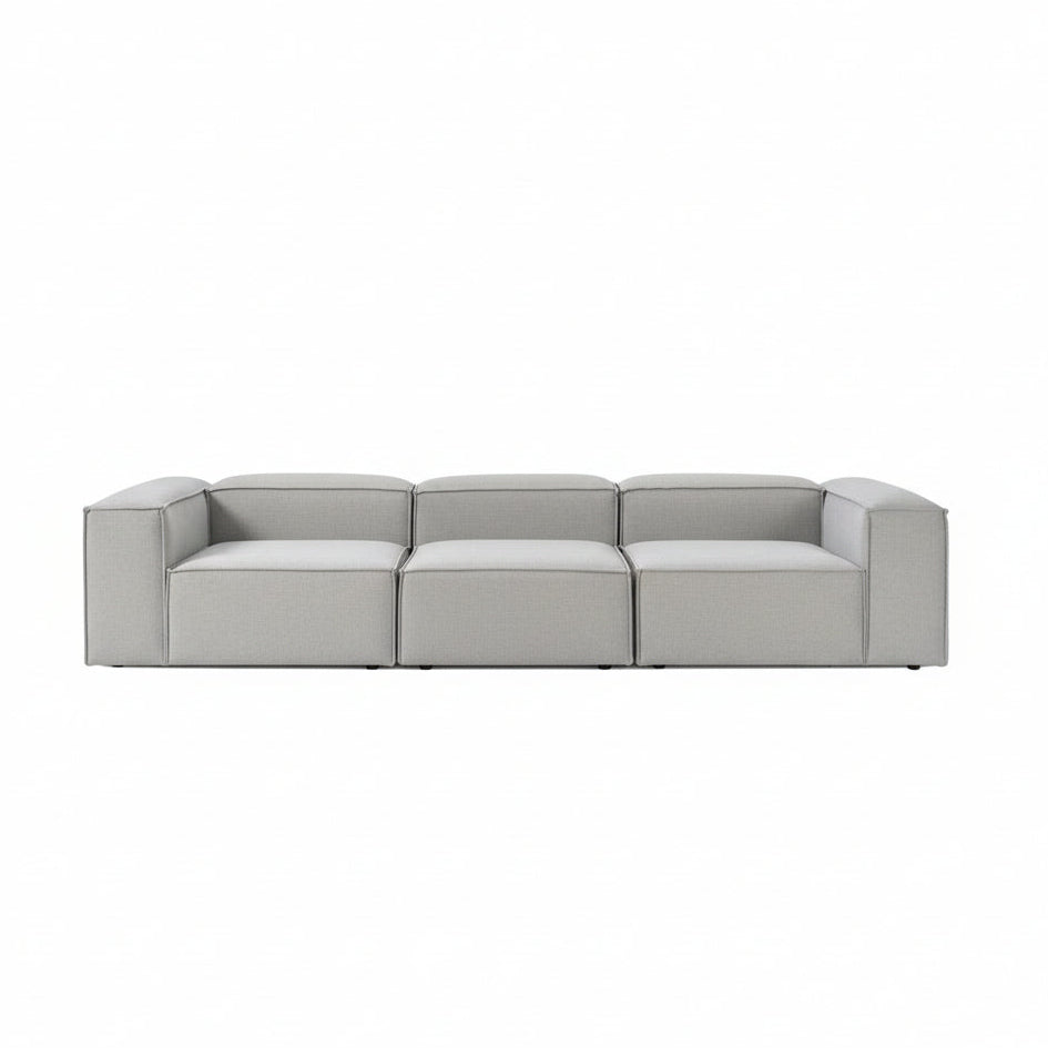 Luxury Alpha modular 3 seater sofa in soft neutral fabric with wide structured seats, low-profile silhouette, and clean contemporary lines for modern interiors
