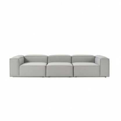 Luxury Alpha modular 3 seater sofa in soft neutral fabric with wide structured seats, low-profile silhouette, and clean contemporary lines for modern interiors
