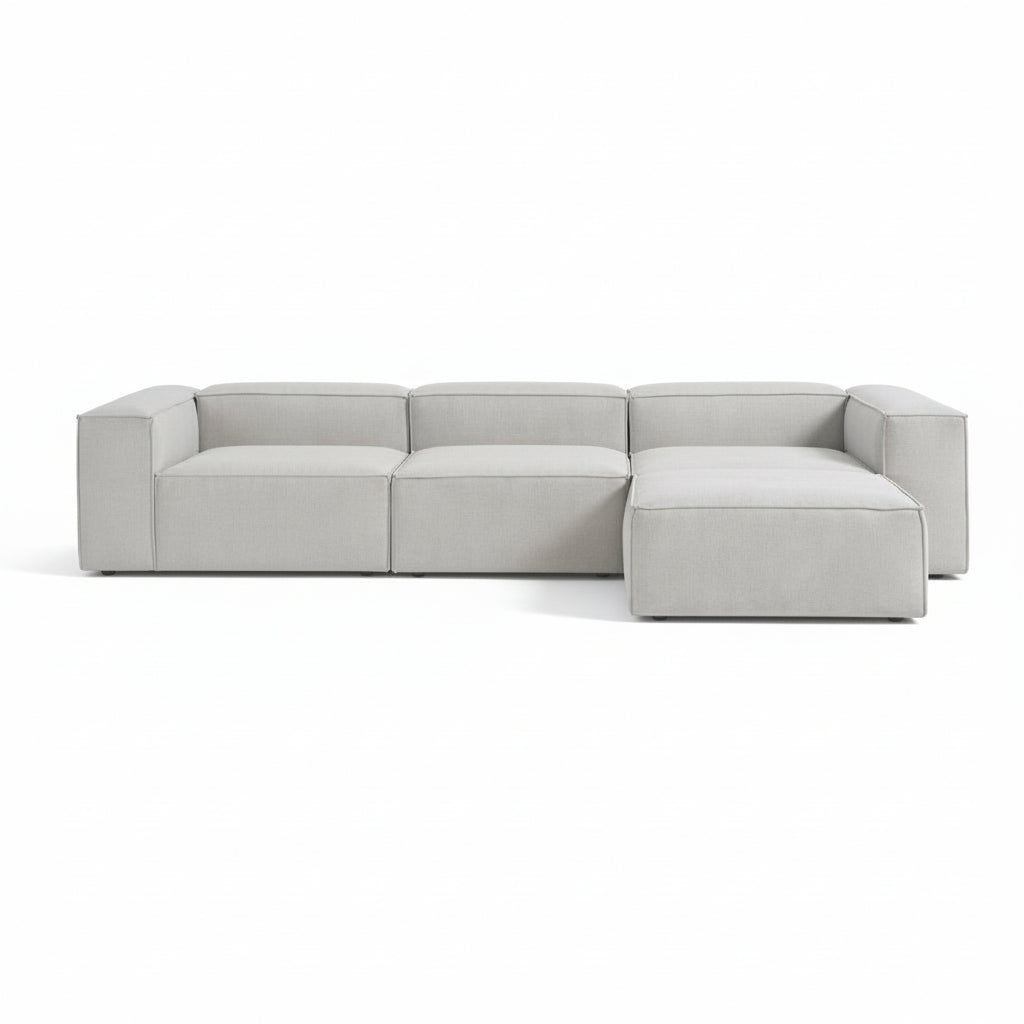 Alpha modular 3 seater paired with a matching stool, featuring a structured shape and deep seating for a relaxed, adaptable layout
