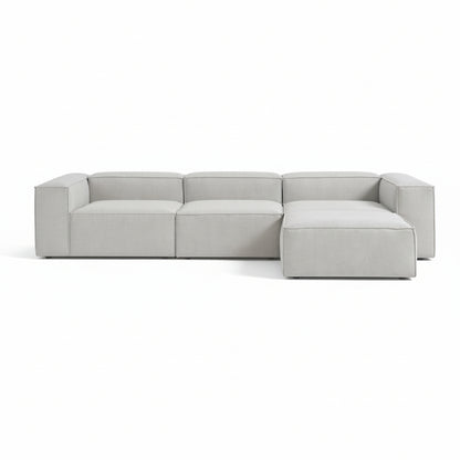 Alpha modular 3 seater paired with a matching stool, featuring a structured shape and deep seating for a relaxed, adaptable layout
