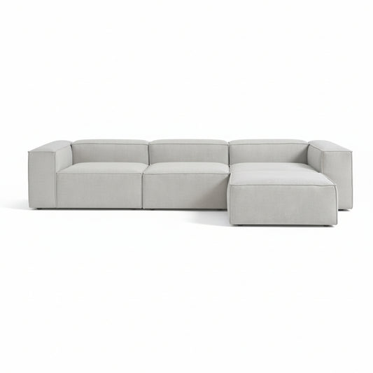 Alpha modular 3 seater paired with a matching stool, featuring a structured shape and deep seating for a relaxed, adaptable layout
