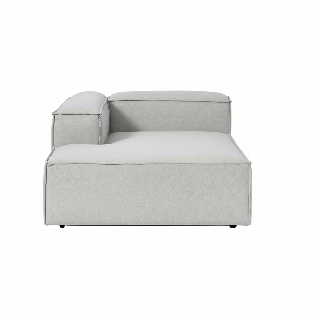 Luxury Alpha modular chaise sofa in neutral textured upholstery with deep seating, clean lines, and contemporary low-profile design for modern living spaces