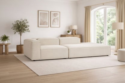 Alpha modular sofa configuration in premium neutral fabric, styled in a refined living space with a low-profile, architectural silhouette
