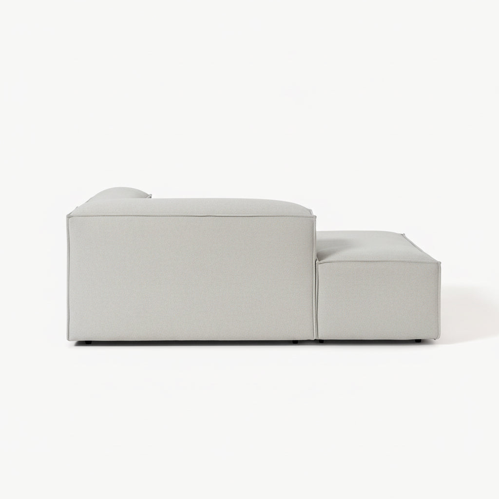 Designer Alpha modular sofa with integrated chaise and ottoman extension, offering generous lounging space, clean lines, and a sophisticated contemporary finish