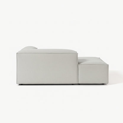Designer Alpha modular sofa with integrated chaise and ottoman extension, offering generous lounging space, clean lines, and a sophisticated contemporary finish