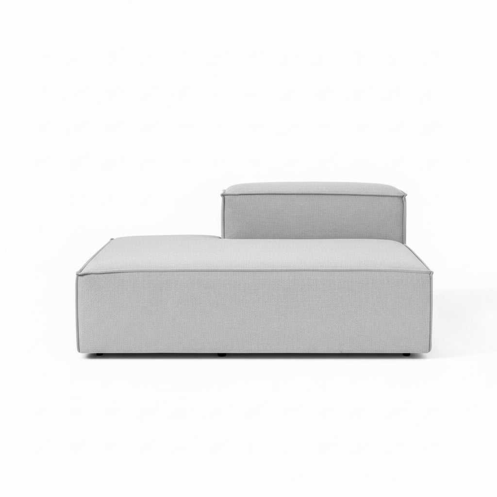 A clean, structured ottoman with a minimalist silhouette, designed to complement modular configurations with added versatility and comfort