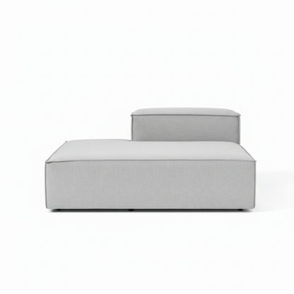 A clean, structured ottoman with a minimalist silhouette, designed to complement modular configurations with added versatility and comfort