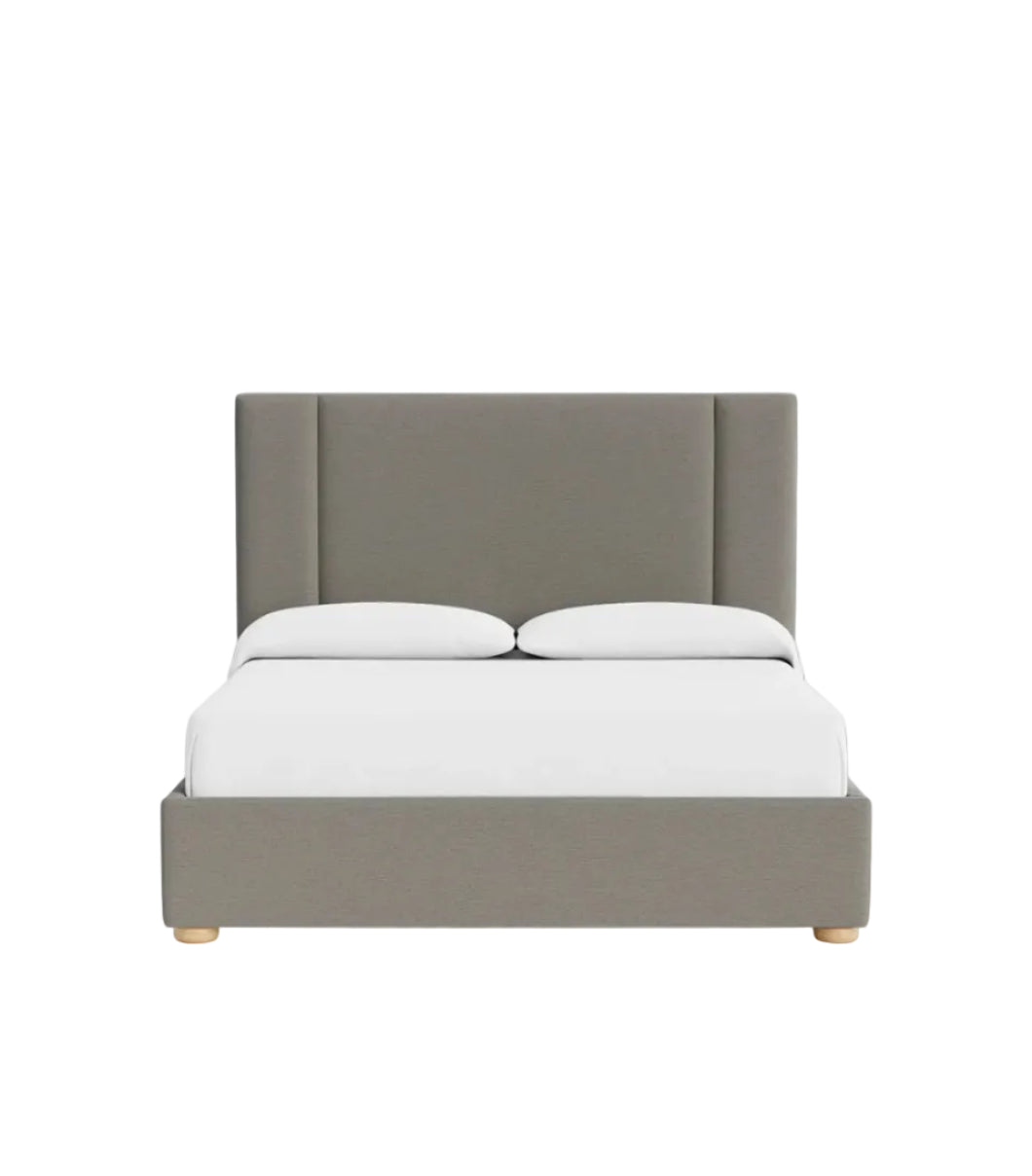 Front view of Ashton bed featuring soft padded headboard panels and minimalist base