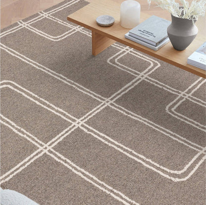 The Astoria Rug styled within a contemporary living room, showcasing its soft wool texture and timeless neutral tones that complement modern interiors
