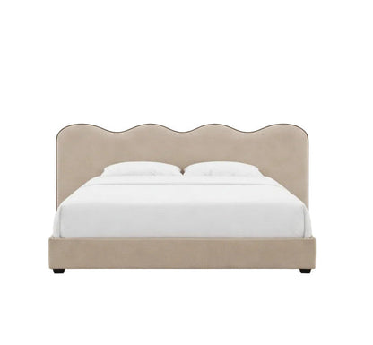 Elegant upholstered frame with a signature scalloped headboard and refined piping detail
