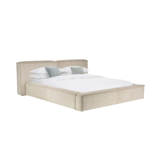 modern bed with padded headboard and soft neutral upholstery