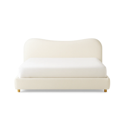 cali bed with curved upholstered headboard and soft neutral fabric base