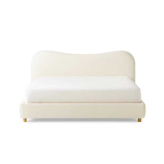 cali bed with curved upholstered headboard and soft neutral fabric base