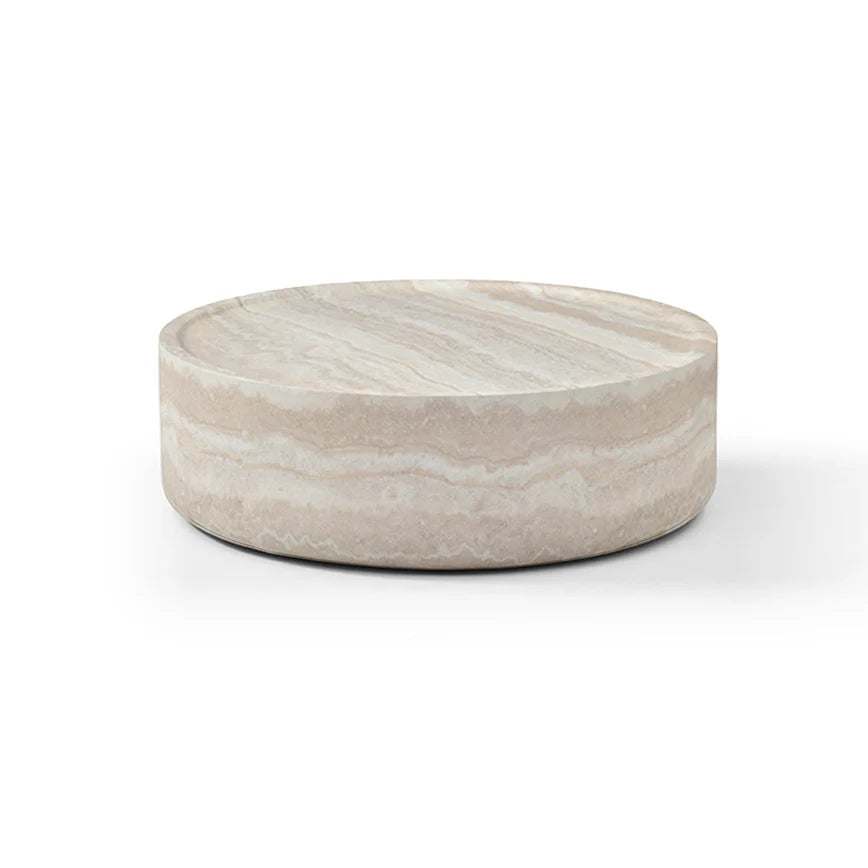 The Cilano Coffee Table is shown in a full studio view on a clean white background, highlighting its large rounded silhouette and faux travertine finish.