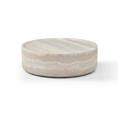 The Cilano Coffee Table is shown in a full studio view on a clean white background, highlighting its large rounded silhouette and faux travertine finish.