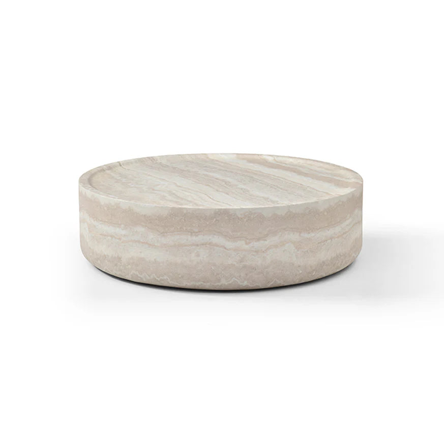 The Cilano Medium Sofa Table is shown in a clean studio view on a white background, highlighting its rounded form and faux travertine finish.