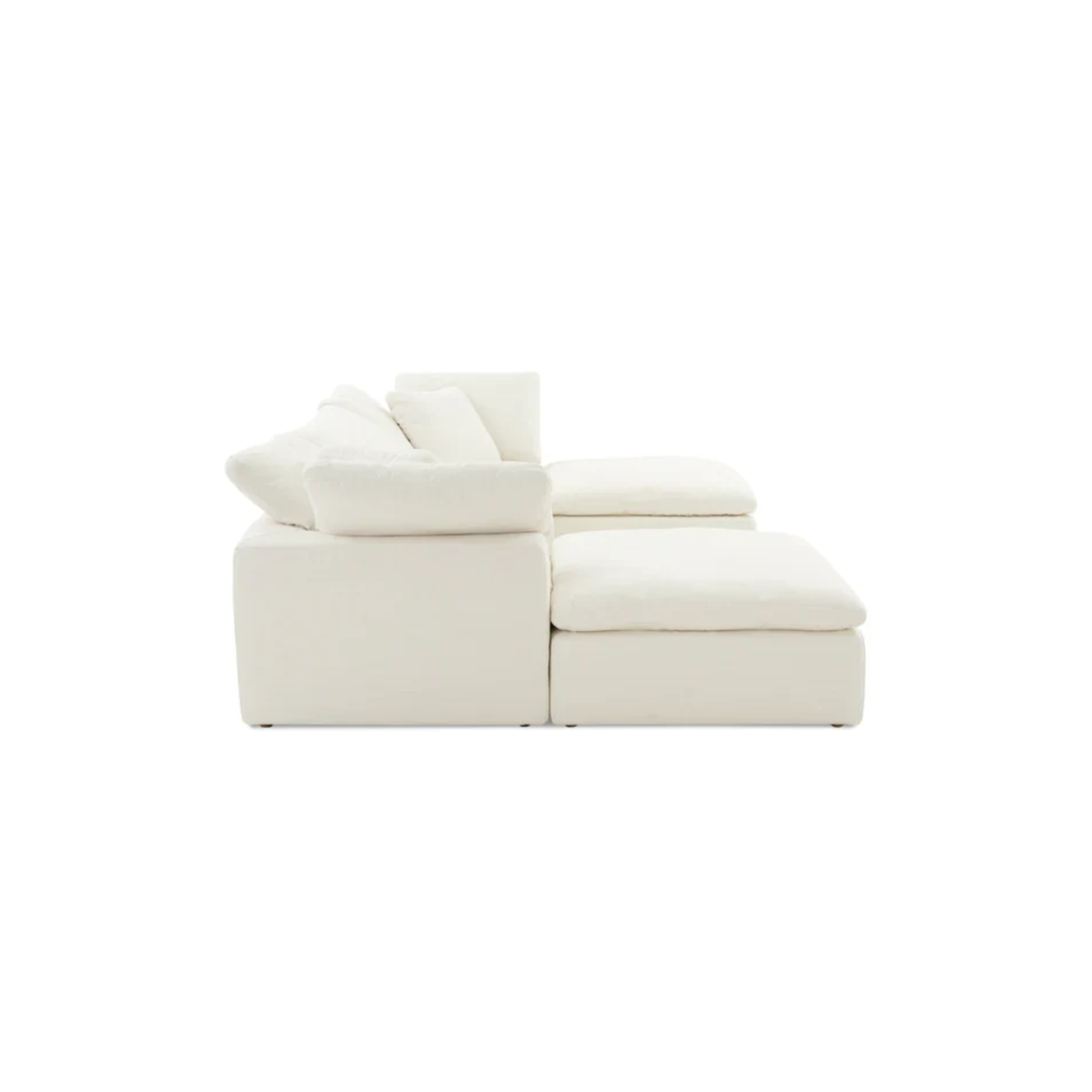 modern U shaped sofa with symmetrical layout and two footstools in neutral upholstery
