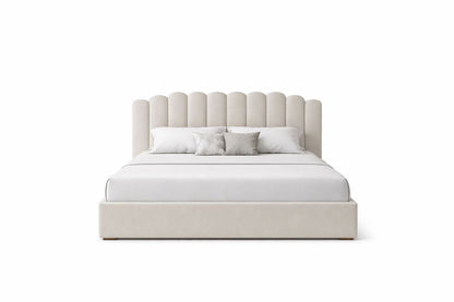 cozy upholstered bed with scalloped cushioned headboard and padded base