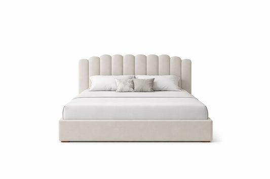 cozy upholstered bed with scalloped cushioned headboard and padded base