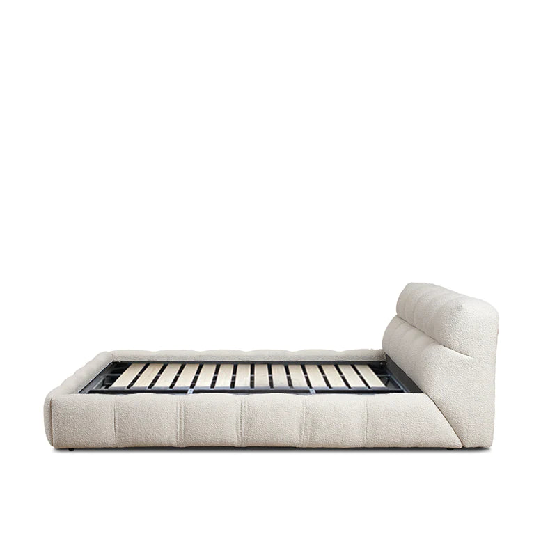 dona bed with vertical panelled headboard and soft neutral upholstery