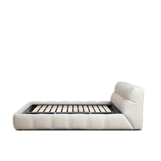 dona bed with vertical panelled headboard and soft neutral upholstery